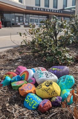 image of painted stones expressing encouragement, outside a hospital